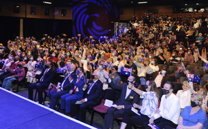 New citizens wave Australian flags at the 2022 City of Wanneroo Australia Day citizenship ceremony.