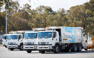 Trucks in front of green trees