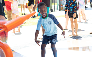 Boy playing in water at Aquamotion
