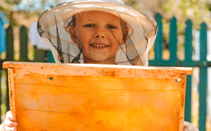 Child with bee hive honey