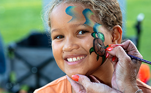 Child having face-painting done