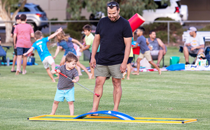 Man and child playing in park