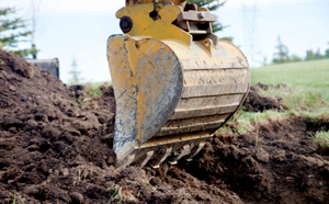 Excavator digging turf