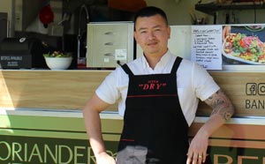 Food truck operator in front of his  truck