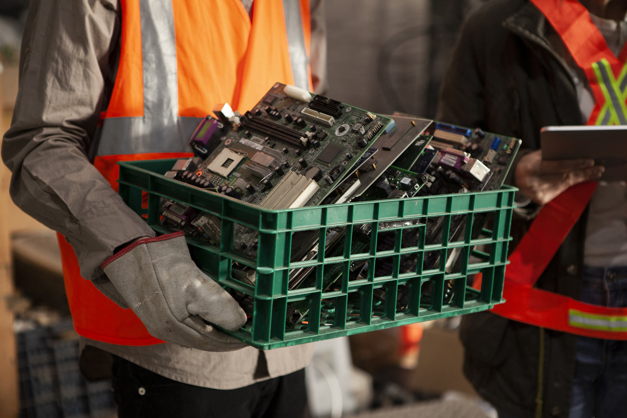 Person in hi-vis holding e-waste