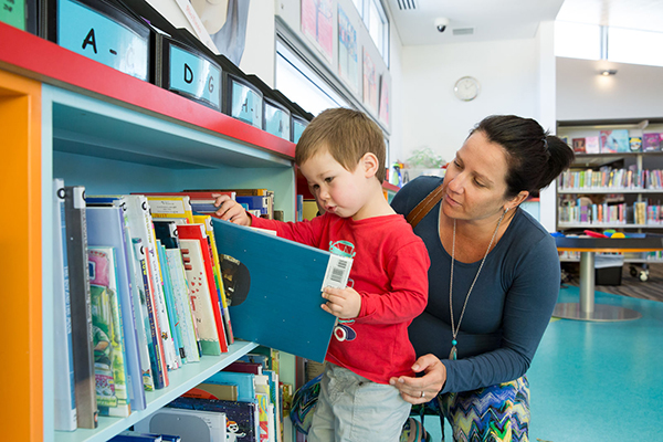 Child reading book at a library