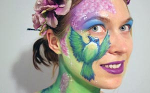 Woman with face painting of a bird