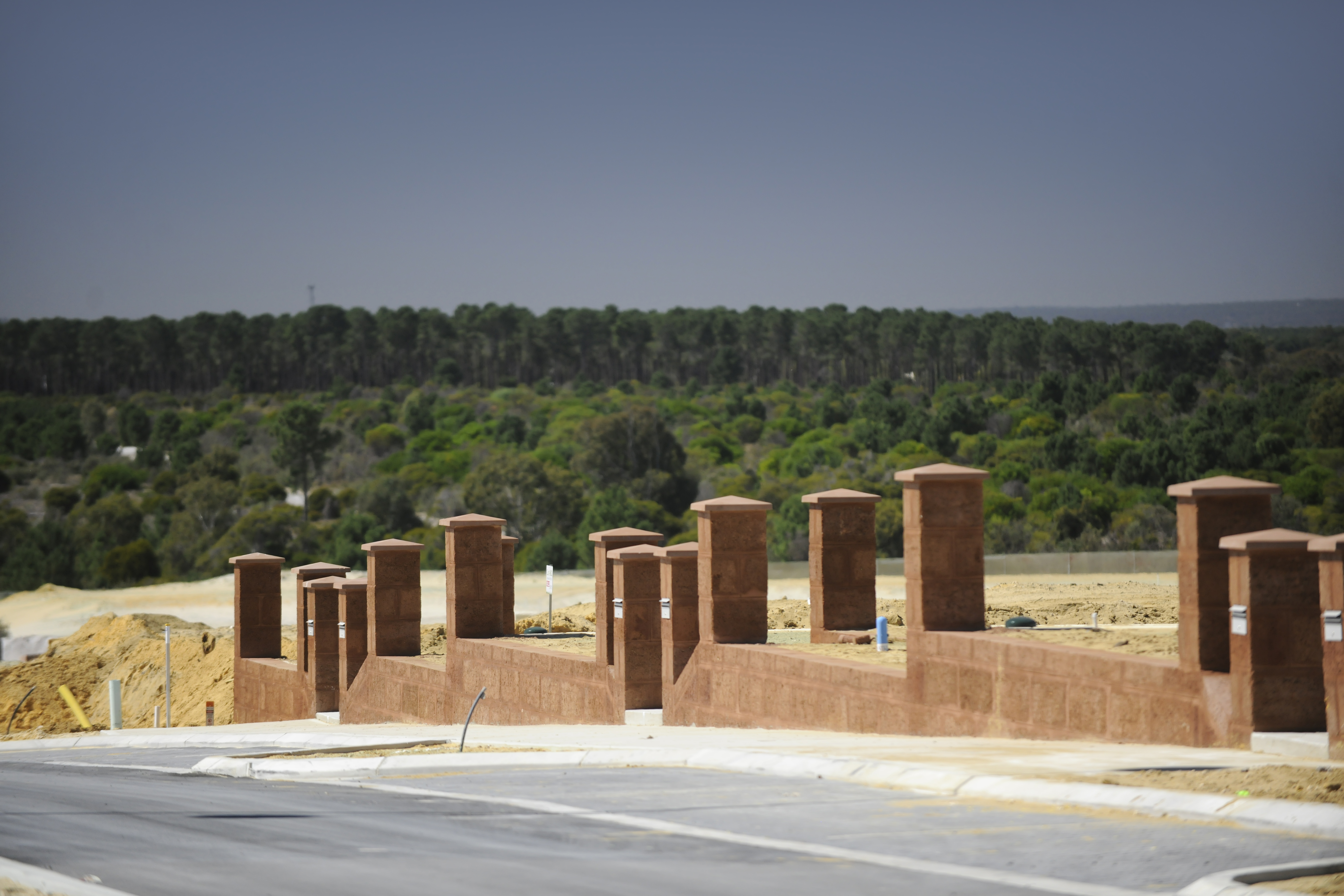 Blocks under construction with trees in background