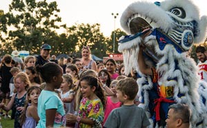 Crowd of children and lion dancer