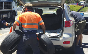 Man disposing of car tyres
