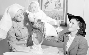 Baby being weighed black and white image