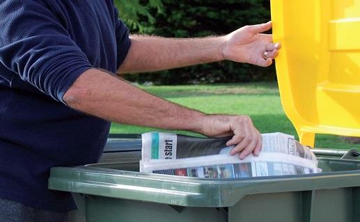 Person placing paper in bin