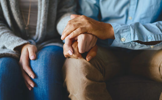 Couple holding hands.