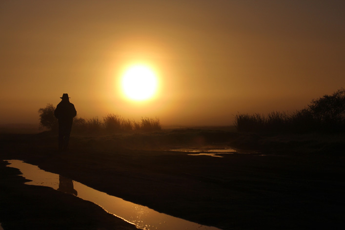 Man walking at sunrise