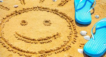 Beach scene with sand and thongs