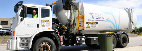 Waste truck picking up bins