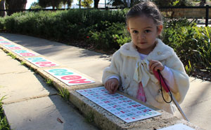 Girl with braille signage