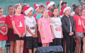 Children singing Christmas carols.
