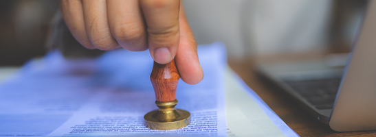 Image of somebody stamping a document