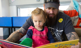 Child and Father reading book