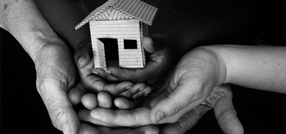 Photo of hands holding a house