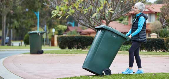 Resident putting bin out for collection