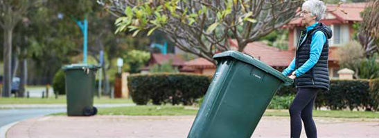 Lady putting bin out for kerbside collection