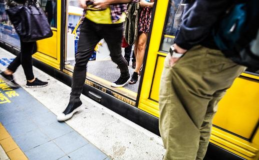 Image of person stepping off a train onto platform