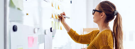 A woman writing on a white board