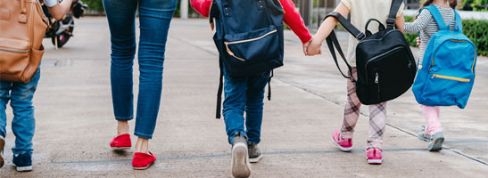 Mother and children walking to school