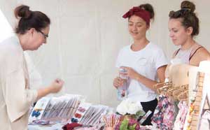 People browsing a market stall 