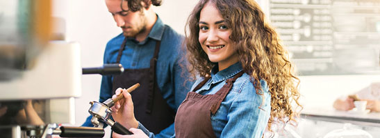 Two teenagers making coffee