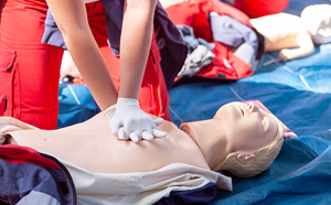Person practicing CPR on dummy