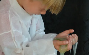 Child with slime in hands