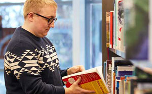 Person reading book at library