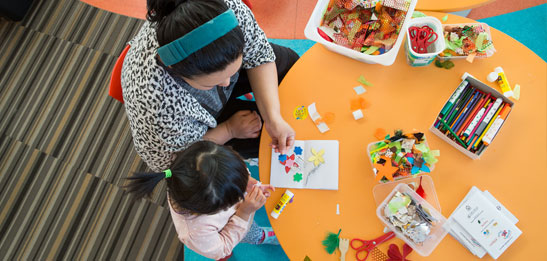 Child and parent doing activities at library