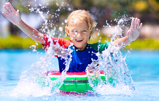 Child playing in pool