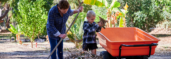 Woman and child clearing leaves