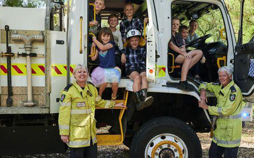 Volunteers and children in fire truck