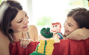 Mother and daughter playing with hand-puppets