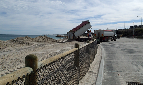 Dump truck delivering sand