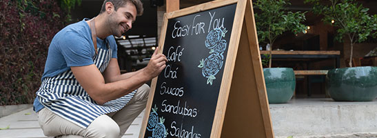 Man writing on signpost