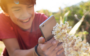 Boy taking photo using phone