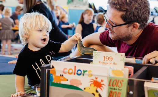 Child and father in library.