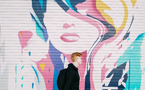 Person walking past street mural