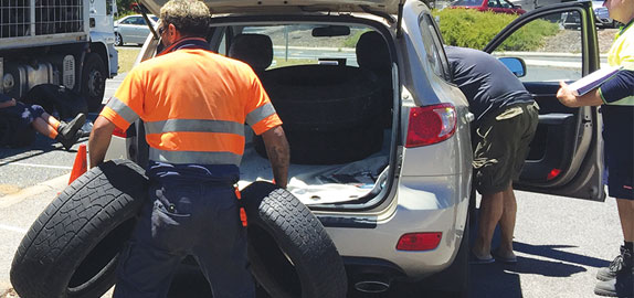 Man disposing of tyres