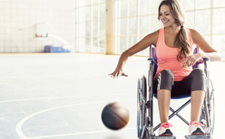 Woman in wheelchair playing basketball