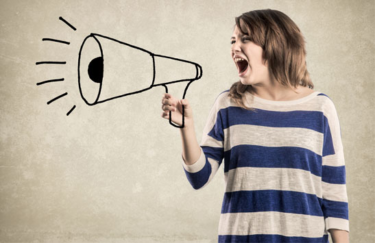 Teenager shouting into megaphone